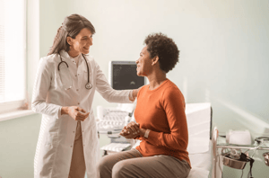 Female medical practitioner reassuring a patient