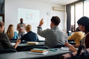 student raising his hand to answer teachers question_632011725-min